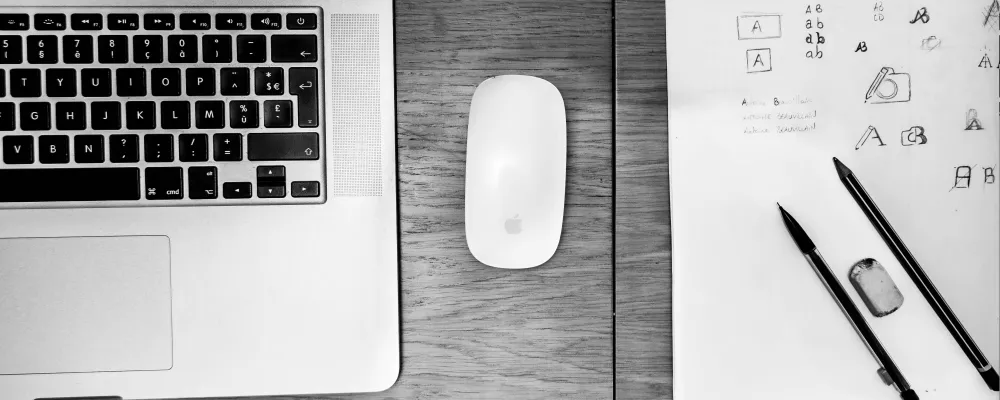 Hero Image showing a laptop, wireless mouse and sketchpad